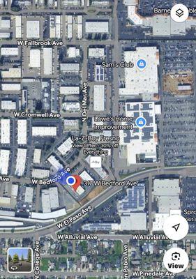 Behind Lowes near Riverpark area. Located near the front parking area there is a blue flag in front of the door