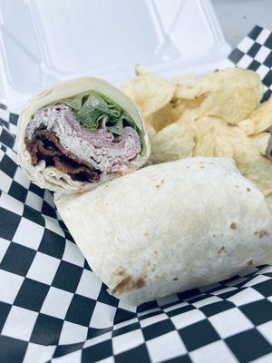 Turkey bacon club wrap- shaved turkey breast, ham, bacon, Romain lettuce, Swiss cheese, and tomatoes with mayo.