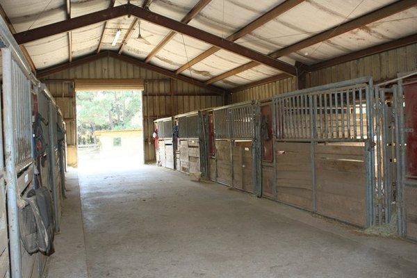 Aisle of the barn with 11 stalls