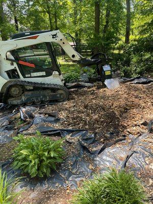 One of our skid steers grinding a stump