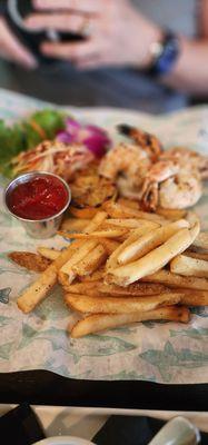 Grilled colossal shrimp with fries and papaya salad