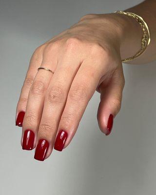 High-shine deep burgundy/classic red full-coverage polish on square nails