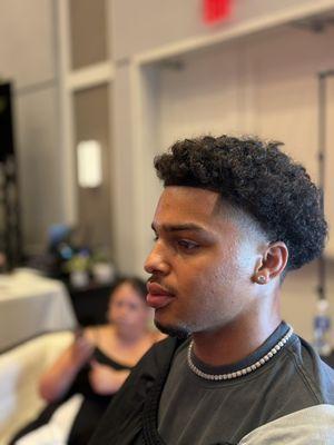 North Liberty high fade with textured curls -- bold and sharp.