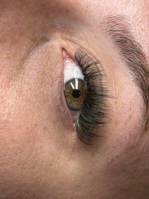 Volume lashes with a hint of green