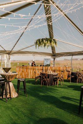 reclaimed wood bar under clear top tent for cocktail party in Smyrna, DE