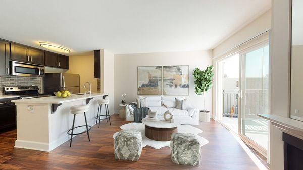 Living and dining area featuring hardwood-style vinyl flooring, and access to a private balcony.