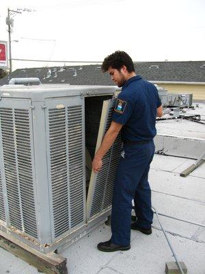Changing out the pads on an evaporator cooler.