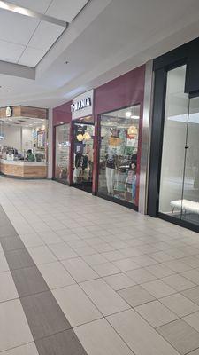 Located inside the mall near Macy's entrance