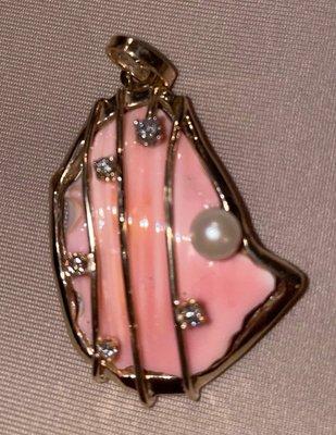 Made out of a conk shell in 14k yellow gold and diamonds