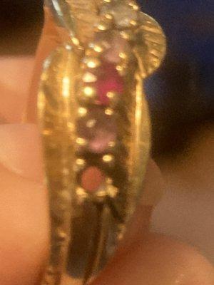 My mother's ring is missing a March stone. Do you do repair. If so. How much approximately. Cold a February stone be added above the oth