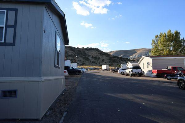 a parking lot in a trailer park with mountains in the background