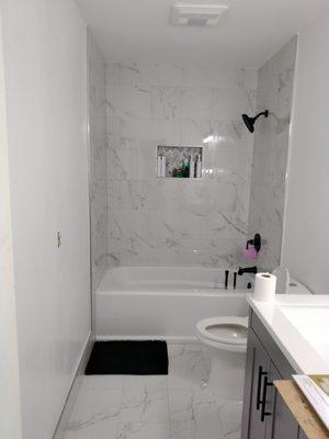 New tub with tile surround and new tile flooring. Full bathroom remodel.