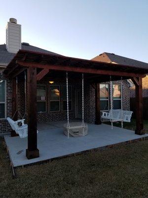 Beautiful pergola with swings and fire pit on new patio