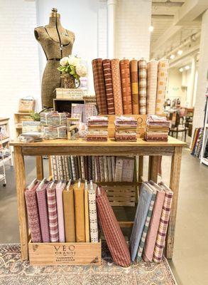 A vintage dress form and beautiful garment fabrics