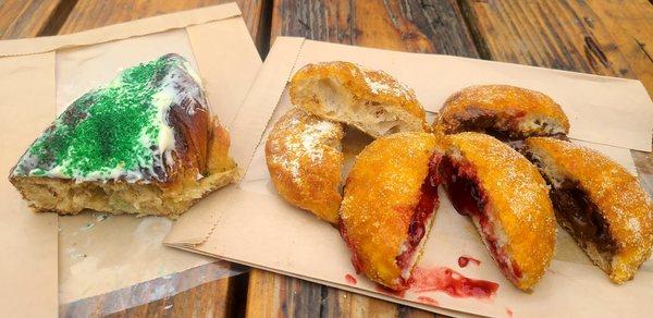 King Cake on the left, beignets on the right: powdered sugar (no filling) shows light and tender texture, raspberry jam, Nutella fillings