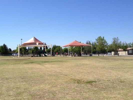 Playground equipment protected by shade screens.