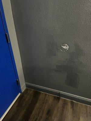 Where the doorknob hits the wall.