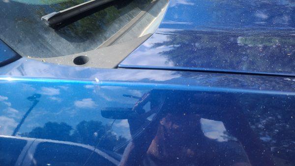 Where antenna used to be and dent on quarter panel