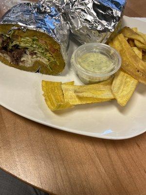 Plantain "wrap" with beef, rice, lettuce with a garlic butter sauce and plantain chips