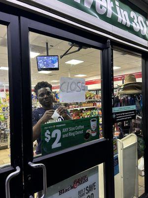 The clerk closing the store as I walk up.