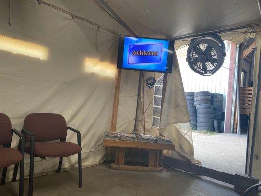 Waiting area with Tv and good amount of seating behind me. Did not want to take a picture of other customers waiting or would have.