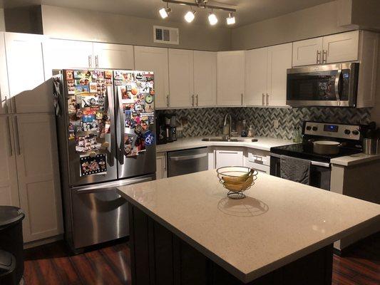 Seems bigger because it's brighter! Tons of counter space now and bar seating at the island! A world of difference!