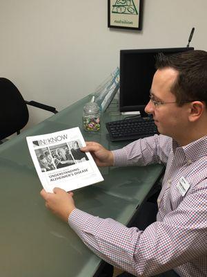 Supervisor Matt reviewing the Alzheimers training manual for caregivers.