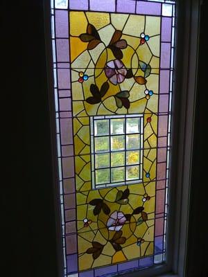 1893 stained glass window on landing.