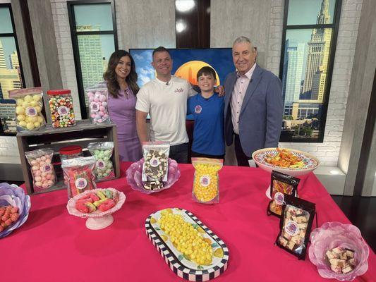 Me and my son on the morning show displaying his candy business