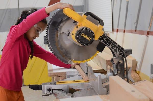 9 year old girl uses the chops saw at Tinkering School