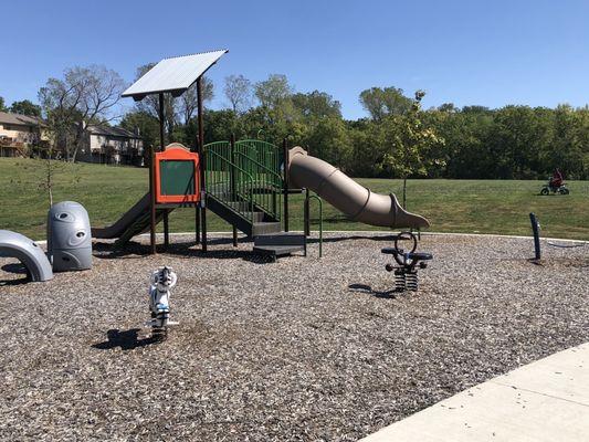 Toddler sized playground across from the larger one