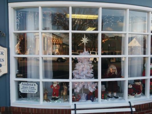 The holiday cheer presented in the window is in sharp contrast to cold-hearted, nasty woman who works inside.