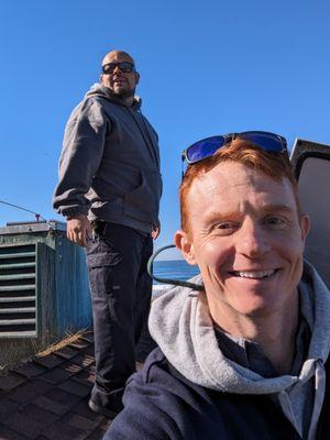 A technician and the owner inspecting roof vents in La Jolla