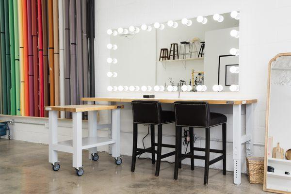 Hair & Makeup Station fitted with a heavy-duty 8' long workbench, Professional Hollywood-style Mirror, Rolling Workbench & 2 Bar Stools
