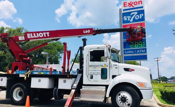 Installing new panels for the pylon at Exxon Mobil