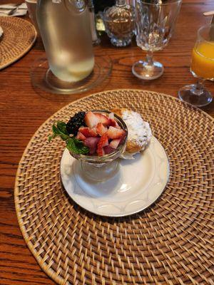 First course of breakfast. Fruit with homemade cream puff
