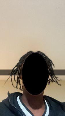 This a photo of the horrible twist the stylist let my boyfriend leave in!