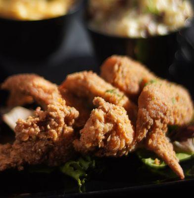 SOUTHERN FRIED CHICKEN three whole wings or one thigh prepared with our own seasoned battered and fried served with two sides
