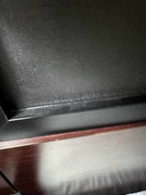 Dust on picture above the bed.