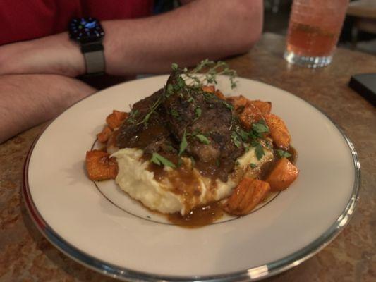 Scrumptious braised short ribs over a red wine reduction gravy, mashed potatoes and roasted carrots.