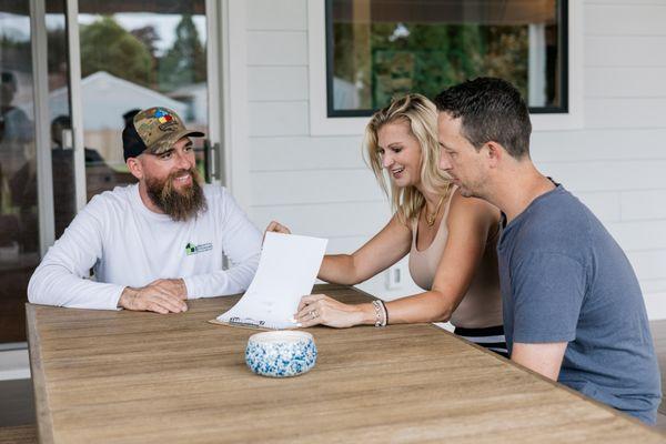 Essential Exteriors owner talking with customers