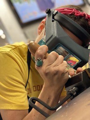 This is a wonderful student setting a stone in silver. Glasses are optional. Haha