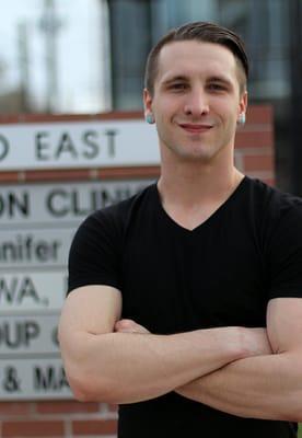 Me in front of our business complex's street sign.