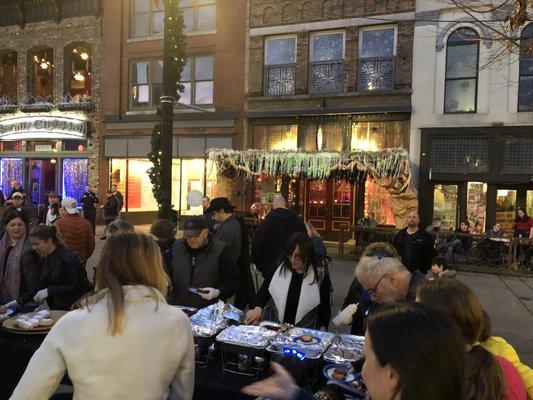 Volunteers serving latkes at the 2019 event.