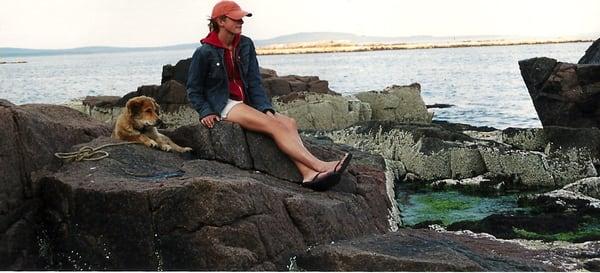 Trainer Alyssa Lapinel and her dog Kodi on the shores of Maine