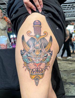 A neo traditional hannya mask with a dagger through it with a tiger moth landing over its eyes by Killian Bundy.