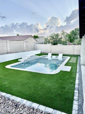 2 ft wall, turf, travertine step stones, paver border and decorative gravel.