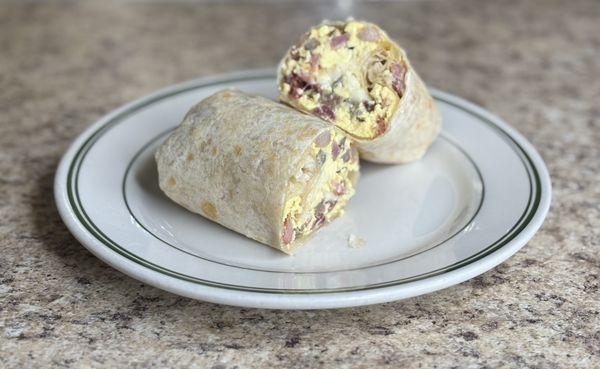 Sofi's Breakfast Burrito:Stuffed with scrambled eggs, crispy bacon, savory sausage, and melted cheese. A warm, hearty way to start your day!