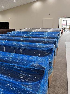 Church benches wrapped to protect them from dust when fixing the drop ceiling