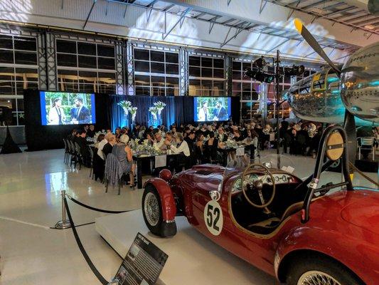 Annual nonprofit get-together at the fabulous Lyon Air Museum. Using dual 14' fastfolds, rear projection, lighting throughout, audio.